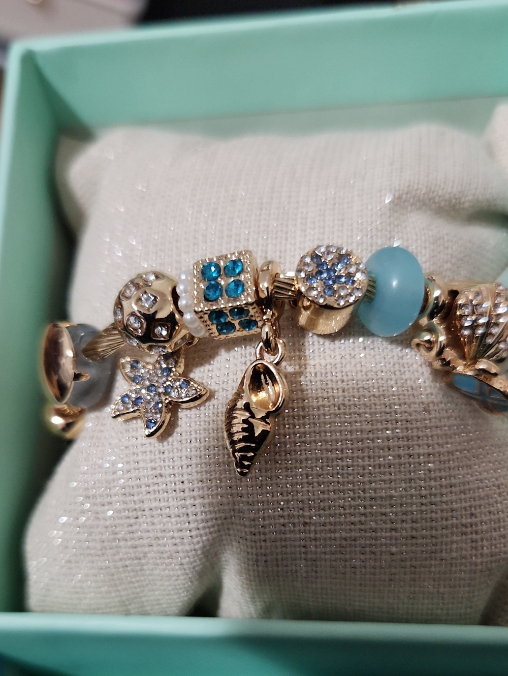 Pipee K Gold Charm Bracelet with Aqua Blue and Crystal Accents